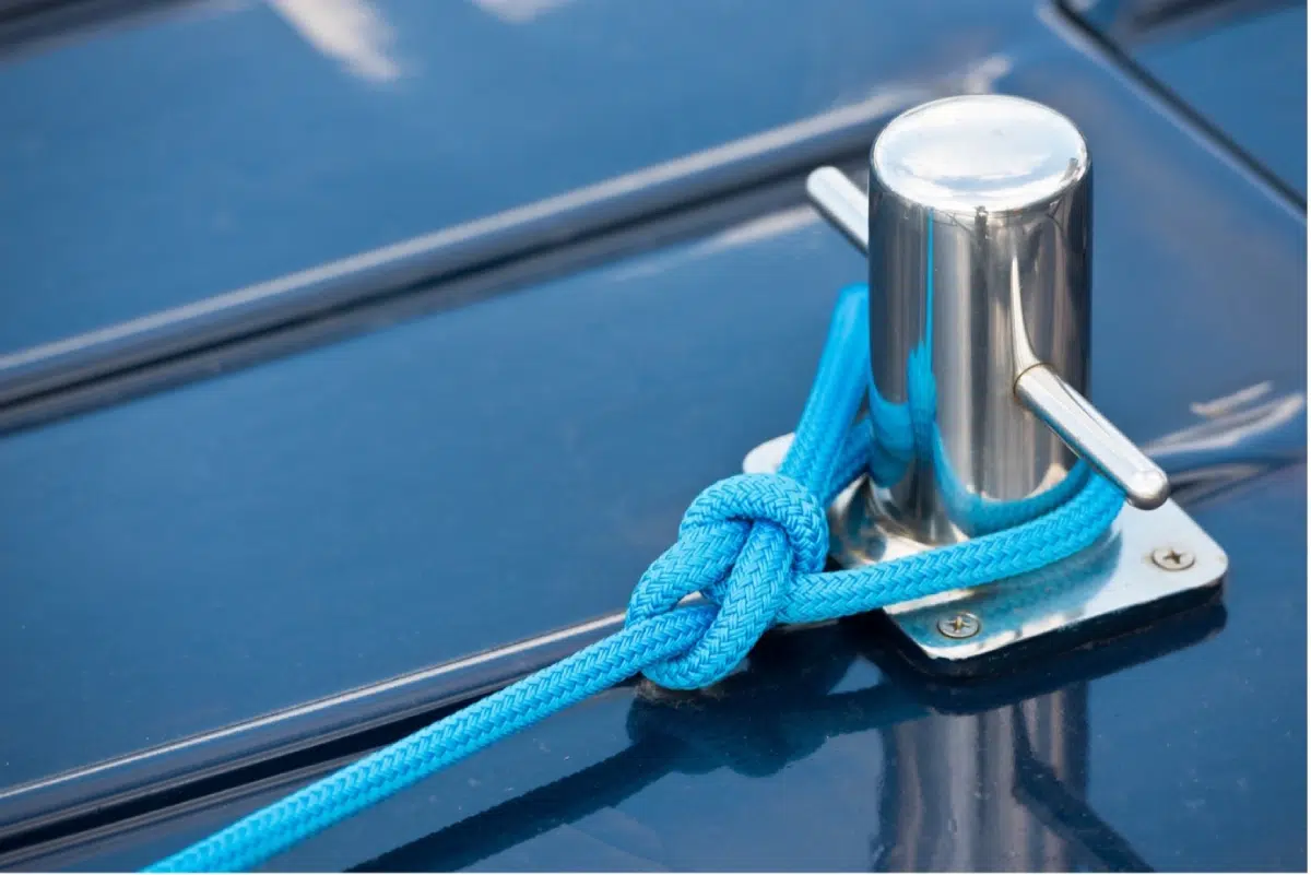 Blue rope tied securely on a metal cleat symbolizing authenticity.