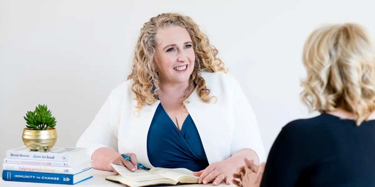 Leadership coach facilitating a reflective conversation during a one-on-one session